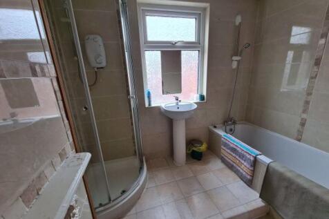 A clean and modern bathroom suite featuring a s...