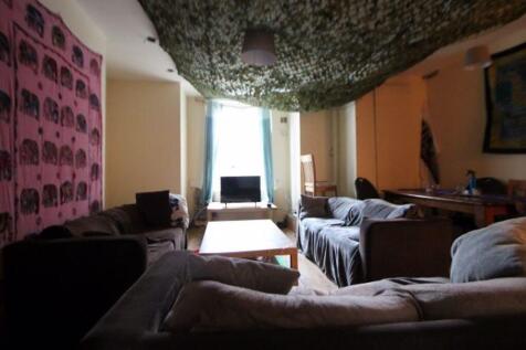 A cozy living room featuring multiple seating o...