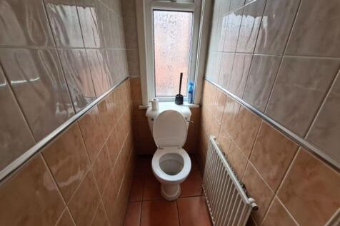 A clean and well-maintained single toilet room ...