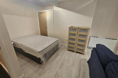 A clean and simple double bedroom featuring a d...