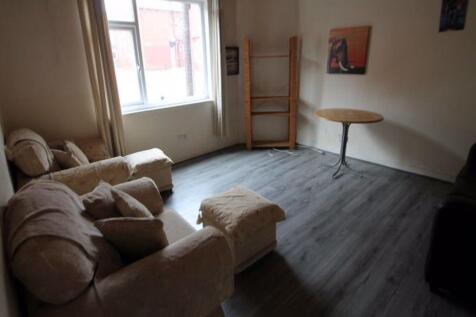 A cozy living room featuring a soft armchair an...