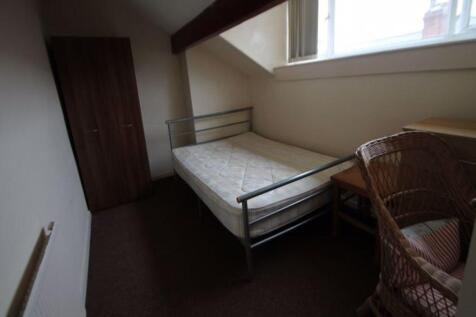 A compact single bedroom featuring a metal bed ...