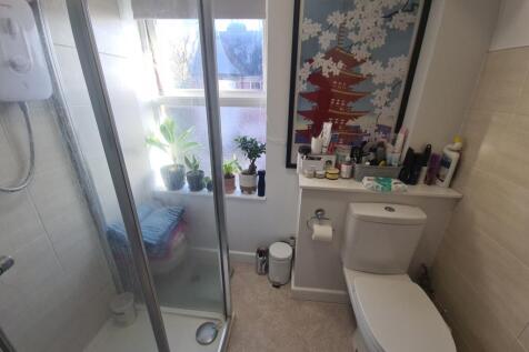 Bright, modern bathroom with a walk-in shower, ...