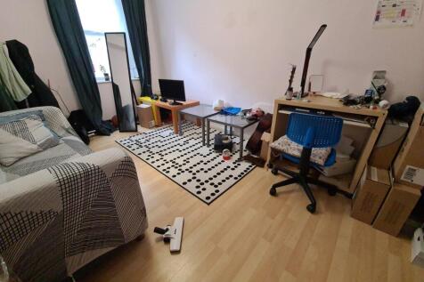 Bright, tidy bedroom with wood-effect flooring,...