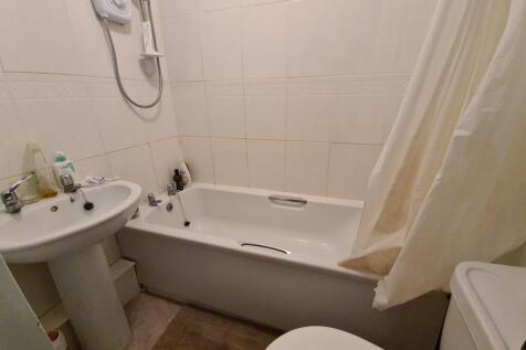 Well-maintained bathroom with a bathtub and sho...