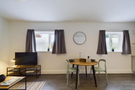 A spacious and inviting modern living room perf...