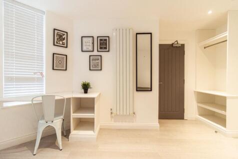 Bright, modern bedroom area with a built-in des...