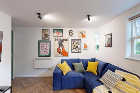 Bright, stylish living room with a blue L-shape...