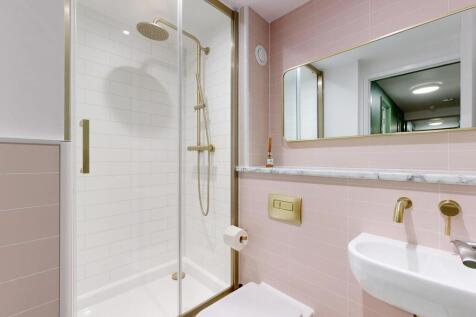 Bright, modern bathroom with a walk-in glass sh...