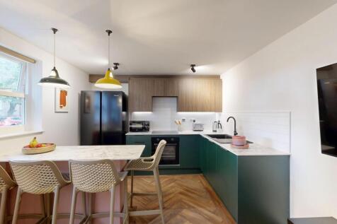 Modern, open-plan kitchen with a breakfast bar,...