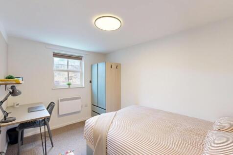 Bright, neutrally decorated double bedroom with...