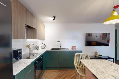 Contemporary kitchen with green lower cabinets,...