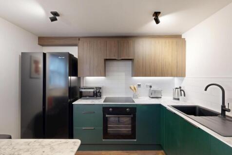 Modern fitted kitchen with two-tone cabinetry, ...