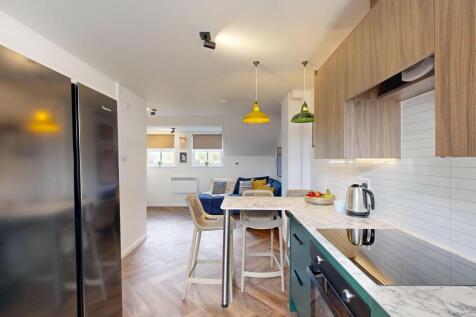 Modern open-plan kitchen with breakfast bar, in...