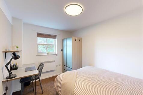 Bright, neatly furnished double bedroom with a ...