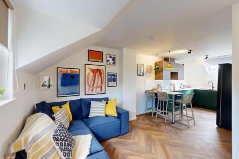 Bright open-plan living area with a cozy blue s...
