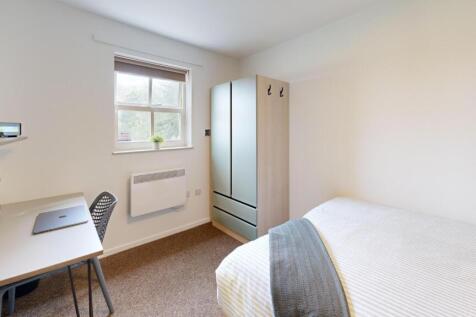 Bright, tidy bedroom with a comfortable bed, st...