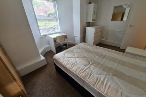 Bright, neutrally decorated double bedroom with...