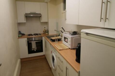 Bright, modern galley kitchen with wood-effect ...