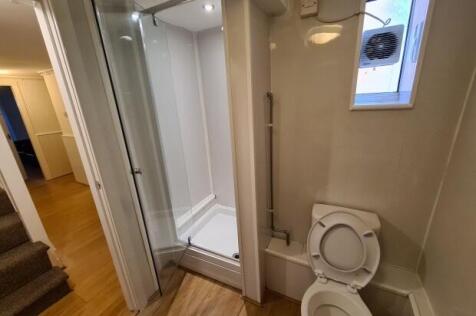 Compact, modern bathroom with a shower cubicle,...