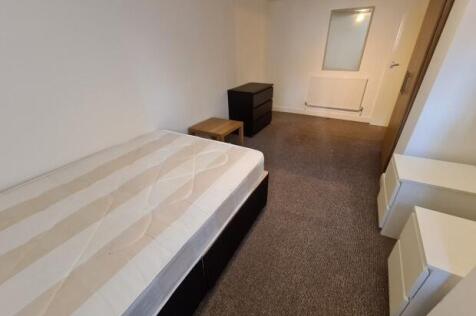 Simple, tidy bedroom with a comfortable bed, ne...