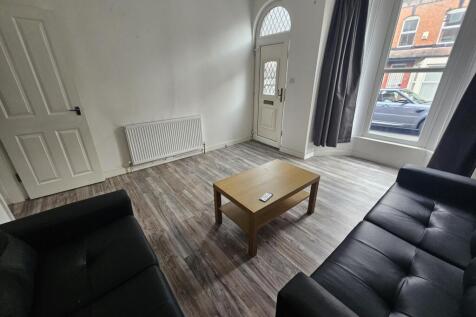 A bright and welcoming living room featuring la...