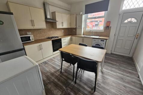 A bright and modern kitchen area featuring a wo...