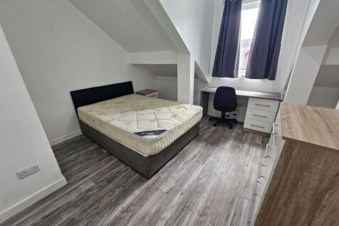 Bright and tidy bedroom featuring a comfortable...