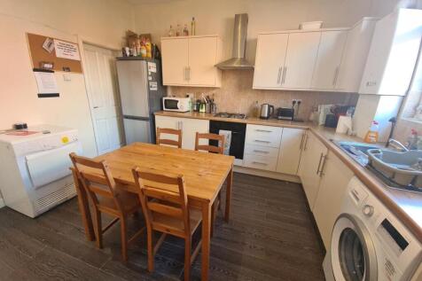 A bright and modern kitchen featuring ample cab...