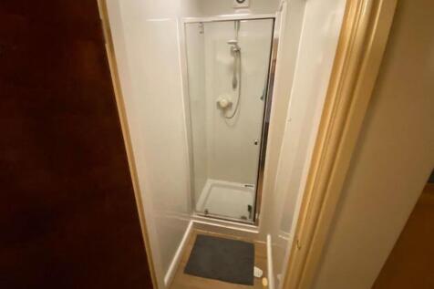 Compact and clean single toilet room with a mod...