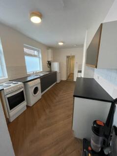 Bright and tidy kitchen featuring modern applia...
