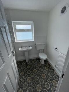 A clean and functional bathroom with a patterne...