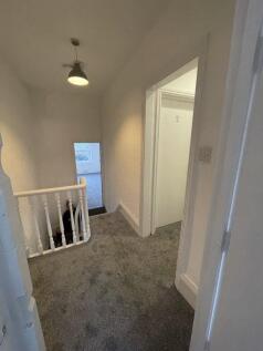 A bright hallway with soft carpeting and white ...