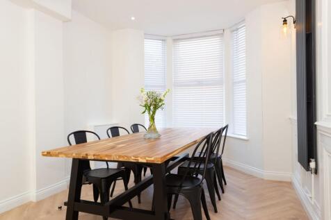 Bright, modern dining/living area with a solid ...