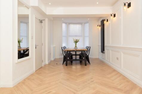 Bright, stylish open dining area with a large b...