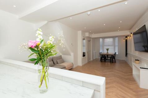 Bright, open-plan living and dining area with h...