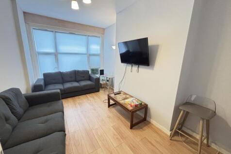 A bright and inviting living room featuring a c...