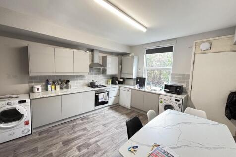 Bright and modern kitchen with ample counter sp...