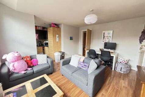 A bright and welcoming living room with comfort...