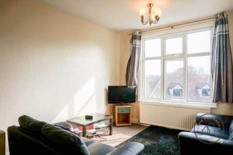 A bright and welcoming living room with a large...