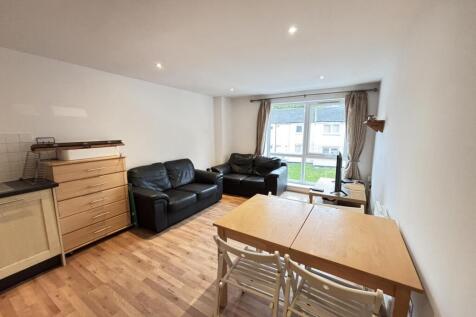 A spacious and well-lit living room with modern...