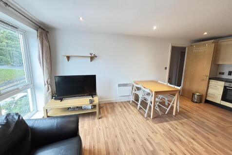 Bright and spacious living area featuring natur...