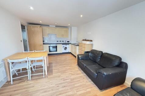 A modern, well-lit living room featuring a comf...