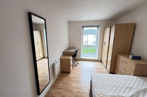 Bright and airy bedroom featuring a comfortable...