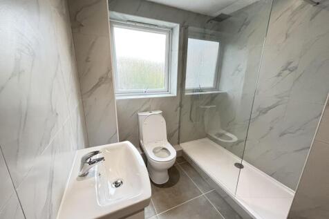 A clean and modern bathroom featuring a large s...
