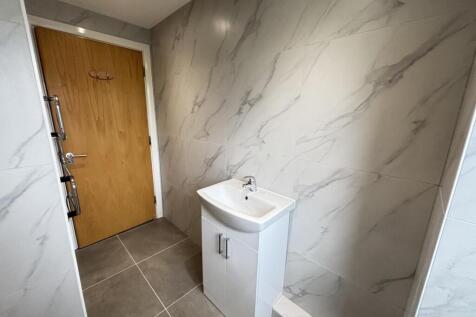 A clean and modern bathroom with a large bathtu...