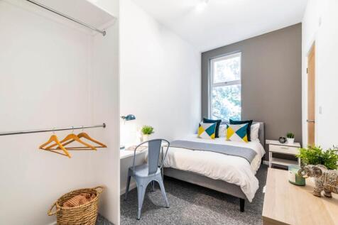 Bright and inviting master bedroom with a comfo...