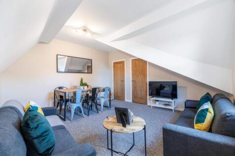 Spacious and modern living room featuring comfy...