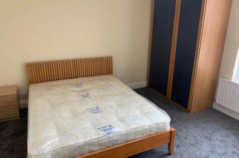 A spacious master bedroom with modern furnishin...