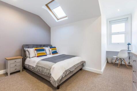 A bright and spacious master bedroom featuring ...